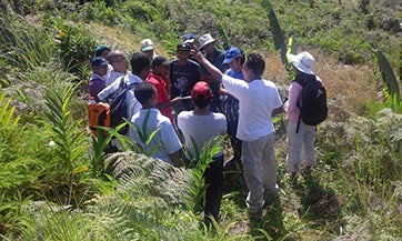 One instructor explaining technical aspects near a plot within the secondary forest 